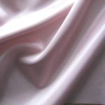 Dusky pink acetate fabric for garment lining.