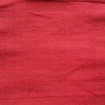 Dupioni silk fabric in blood-red color ideal for suits, jackets, blazers, pants, dresses, skirts, and vests.