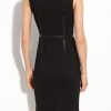 Black dress with leather trims in sleeveless cut with zipper back closure full back view.