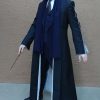 Fantastic Beasts Percival Graves black coat in a mean face posture with wand down.