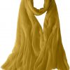 Featherlight cashmere scarf in nugget gold color, pocketable, lightweight, & ultra-soft to keep you warm weigh just ounces, essential for all women.
