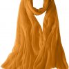 Featherlight cashmere scarf in carrot orange color, pocketable, lightweight, & ultra-soft to keep you warm weigh just ounces, essential for all women.