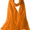 Featherlight cashmere scarf in carrot color, pocketable, lightweight, & ultra-soft to keep you warm weigh just ounces, essential for all women.