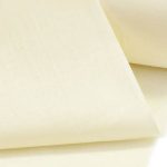 Lightweight butter color cotton fabric for trims and piping in the custom-made garments.