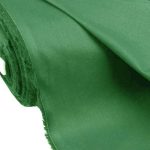 Lightweight green cotton fabric for trims and piping in the custom-made garments.