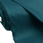 Lightweight green teal cotton fabric for trims and piping in the custom-made garments.