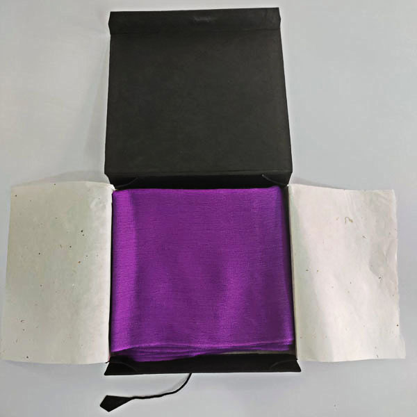 Women's royal purple cashmere wrap scarf with the hemmed edge in a hand-made hard-covered paper box.