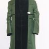 Full interior front view of the green velvet frock coat on a stand with the lining, pockets, and facing details.